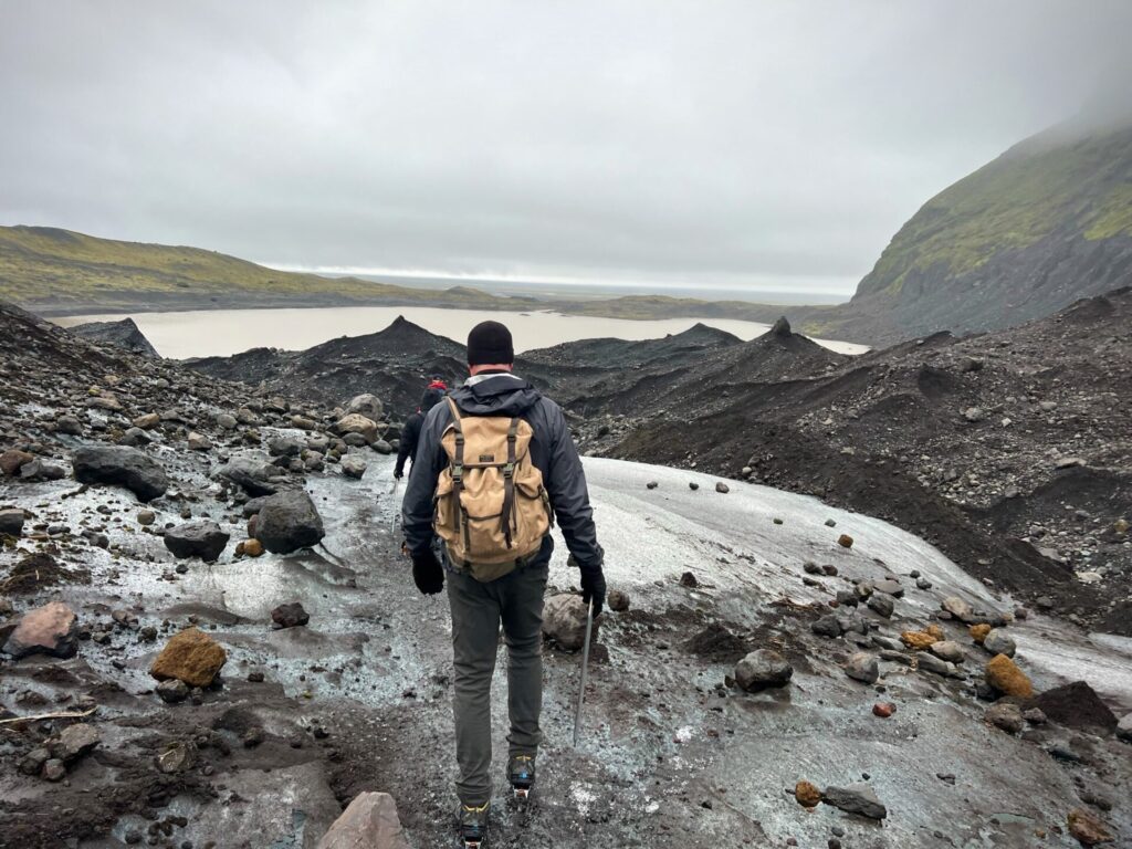 Person Walking On Glacier Ice Surface Wearing Crampons Stock Photo